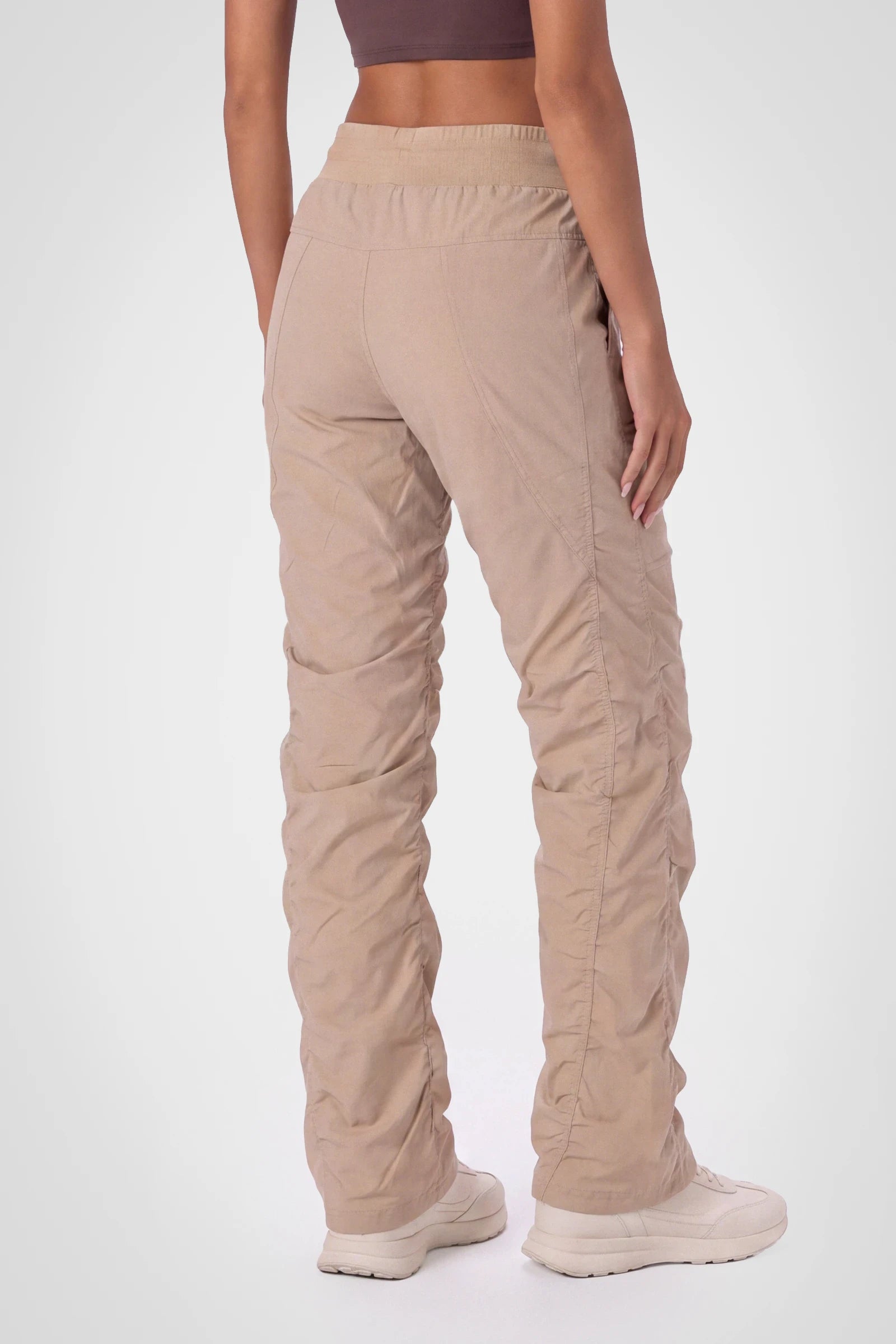 Women’s Doeskin Adventurous Pant, three-quarter studio view showing the tapered leg and gathered hem.